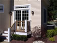 Rear french sliding glass door with decorative transom window above 