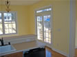 Interior view of a family room sliding glass door with glass transom window above 