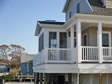 Notice how the sun room fits nicely on the side of the home and on top of the existing deck.