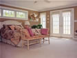 The lovely master bedroom of this Ocean County, Lavallette, NJ home includes french doors to a walk out balcony