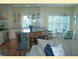 Bright and airy kitchen design opens into an adjoining living area to create a wonderful floor plan flow