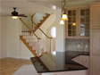 “L” shaped design granite countertop compliments the light oak cabinetry in this Monmouth County, Oceanport, NJ home