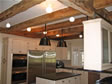 Exposed wooden ceiling beams create an old fashion “farm house” look to any kitchen design