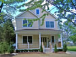 Gable end two-story custom modular home with front porch and expanded rear elevation