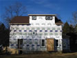 Rear view of a two story modular home with rear shed dormer and privacy windows  