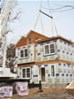 Raising the hinged roof sections on a two story home the day of set, in Monmouth County, Rumson, NJ